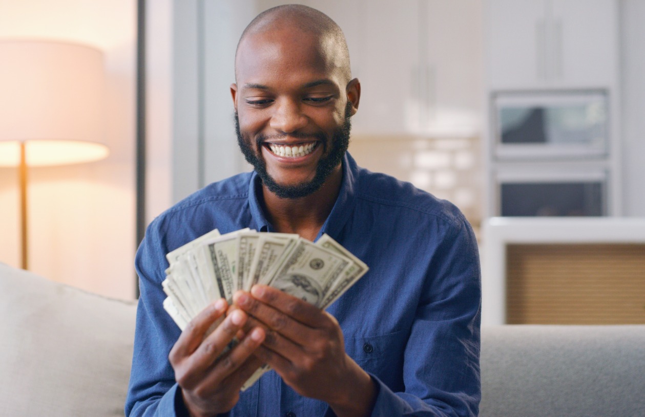Person Holding cash to represent saving money